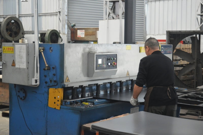 An engineer and a client reviewing warehouse layout blueprints.