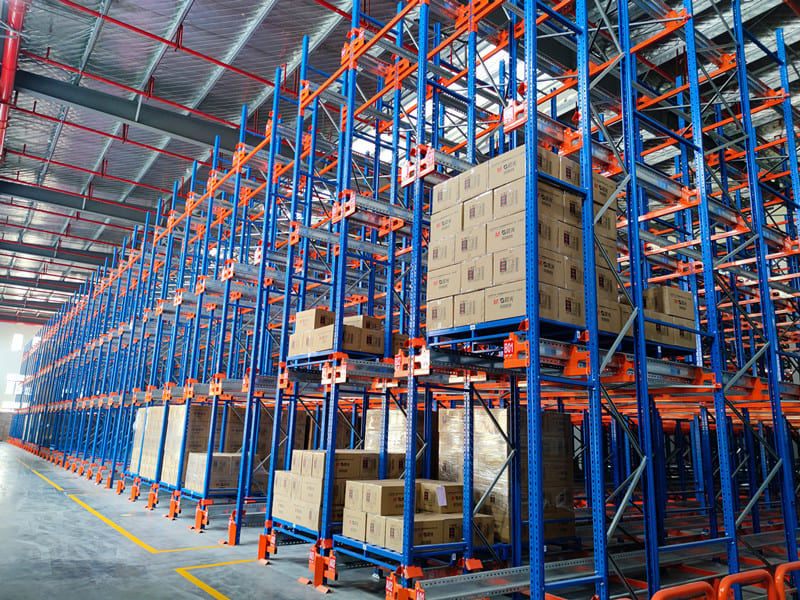 A forklift driver efficiently retrieving a pallet from a high rack level.