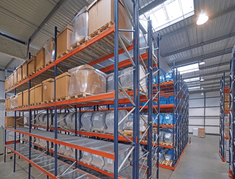 Shipping containers being loaded with pallet racking