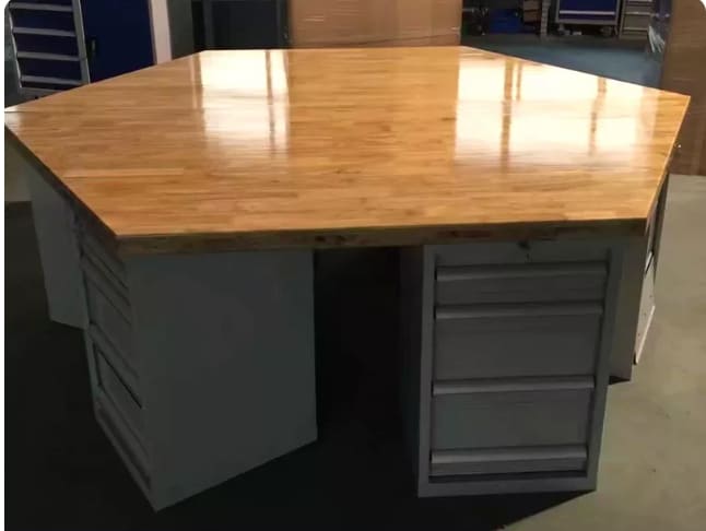 A fully equipped mold maintenance workstation with integrated drawers, a perforated tool board, overhead lighting, and a vise.