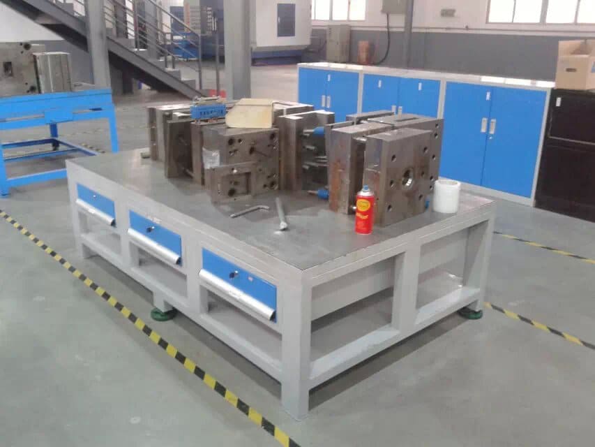 Technician working on a mold placed on a mold table