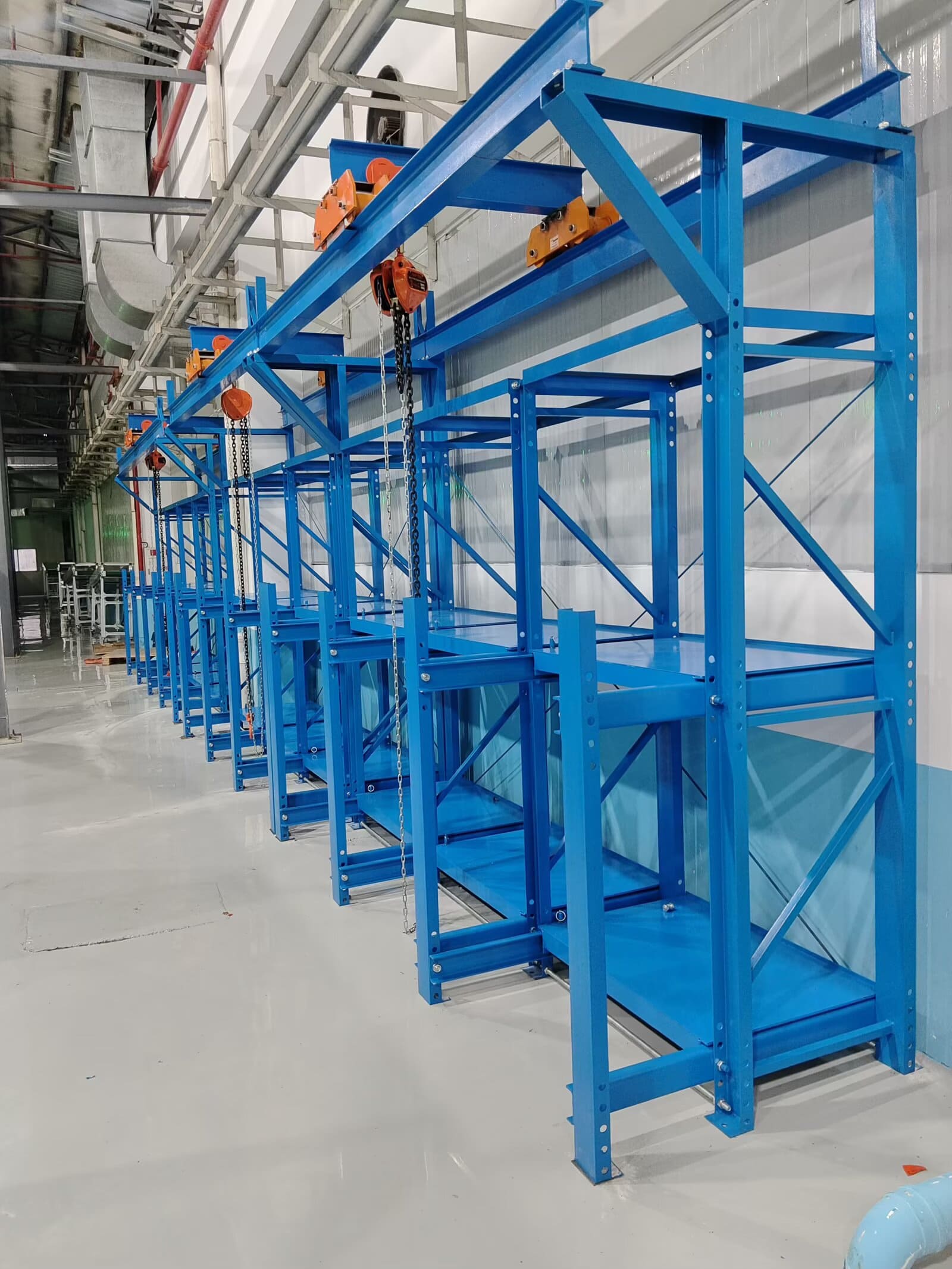 A heavy duty mold rack in a clean workshop environment, with one drawer extended.